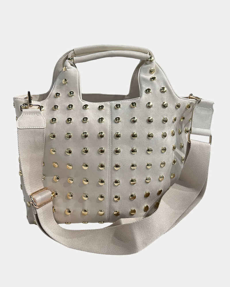Cream vegan suede toteh with gold studs on a white background