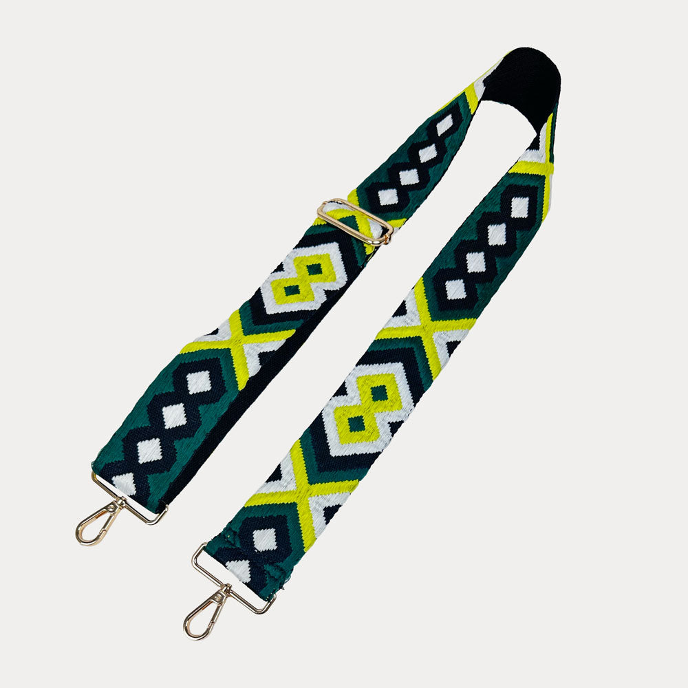 Patterned bag strap with metal clasps on a light gray background