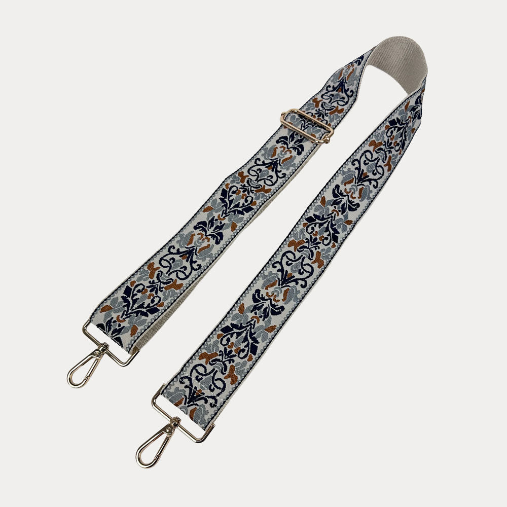 Cream ground Floral pattern bag strap with gold metal clasps on a light gray background