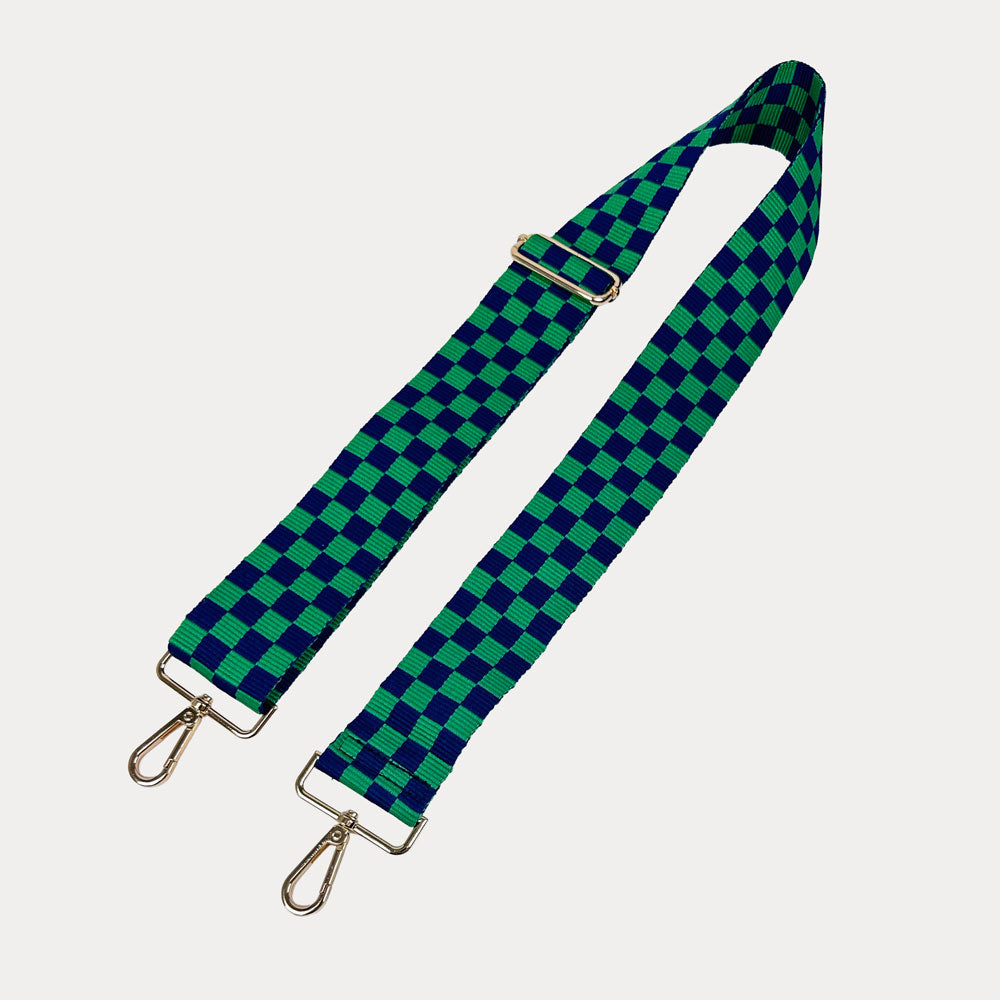 Green and navy checkered bag strap on a white background