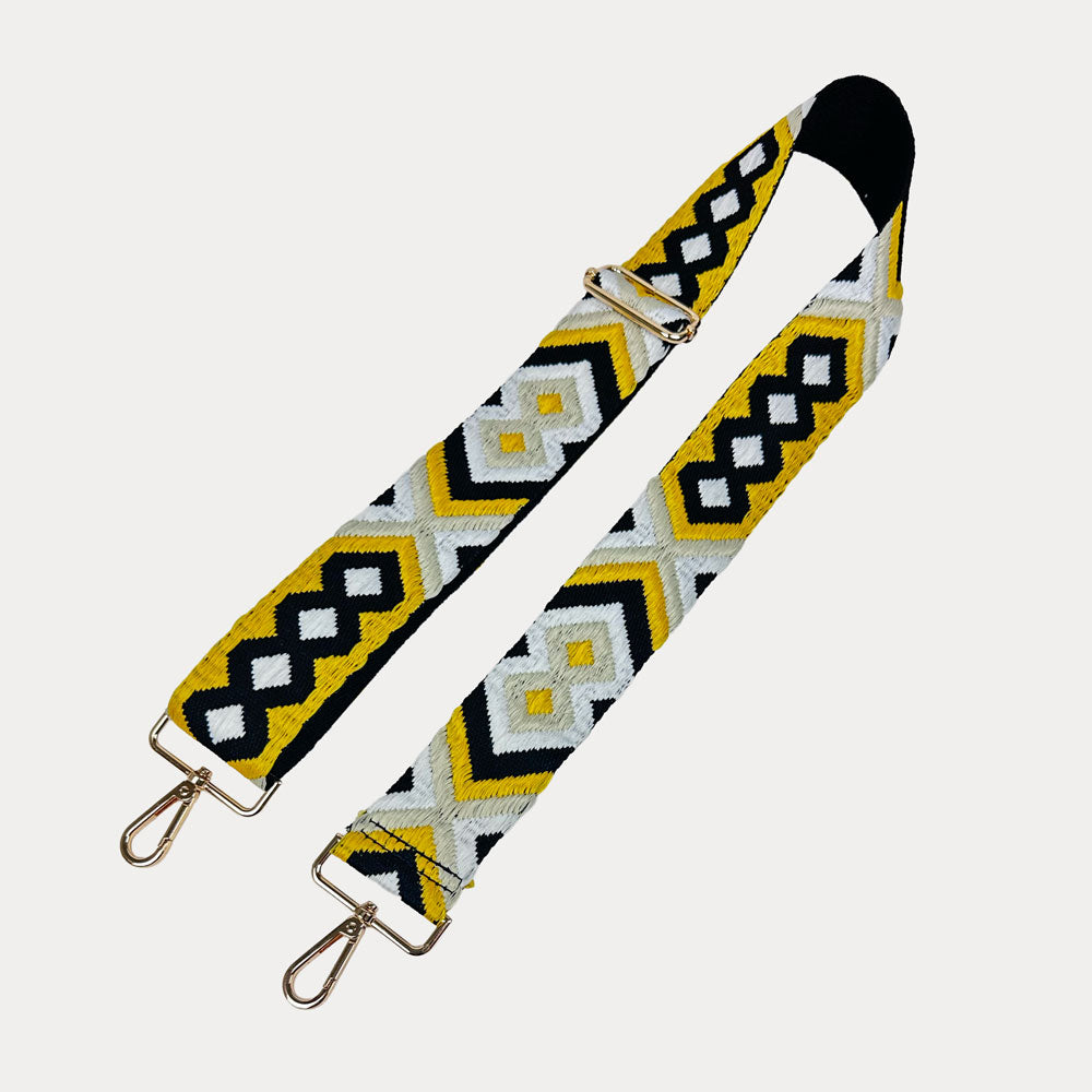 Geometric patterned bag strap on a white background
