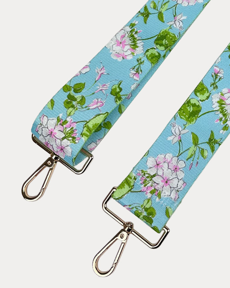 Aqua Ground Floral patterned strap with gold metal clasps on a white background