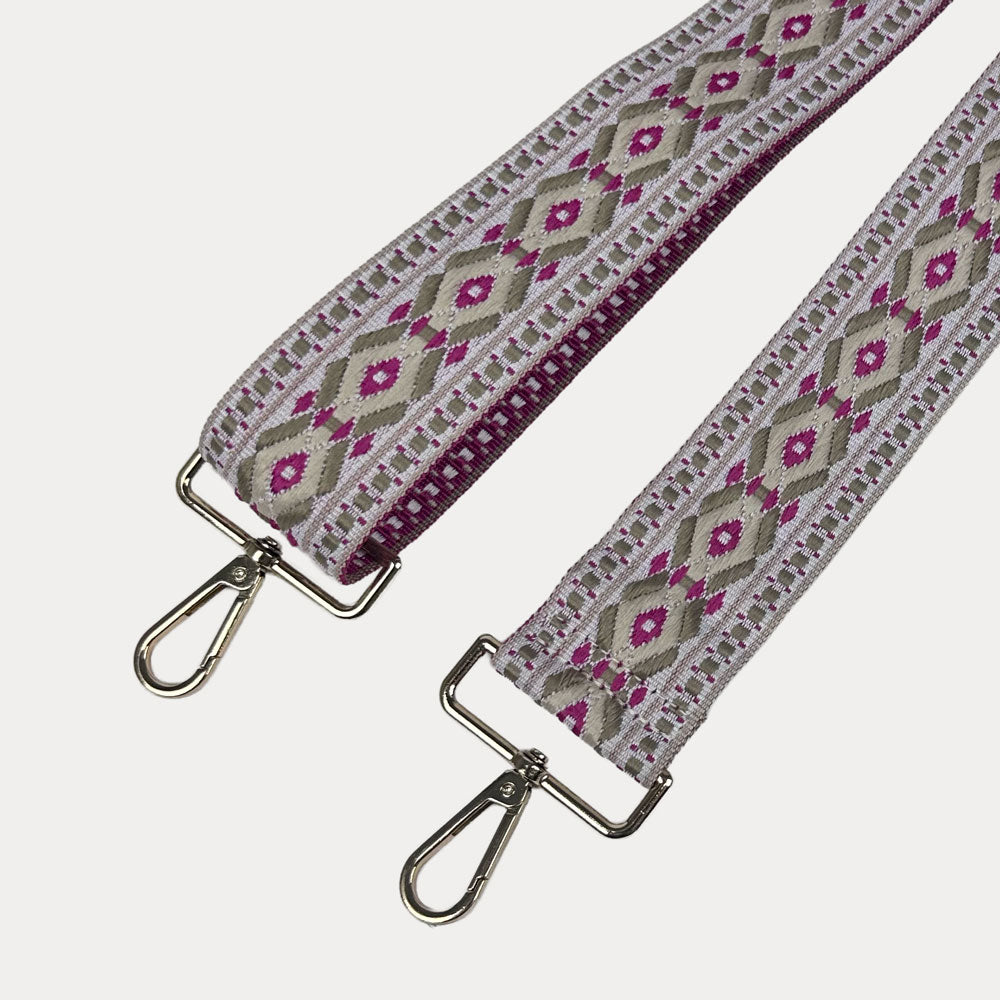 Pink, cream, and grey diamond patterned bag strap with gold metal clasps on a light gray background