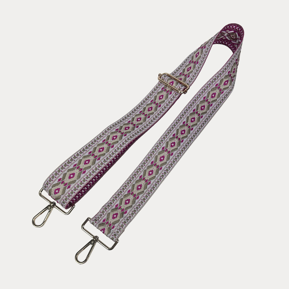 Pink, cream, and grey diamond patterned bag strap on a light gray background
