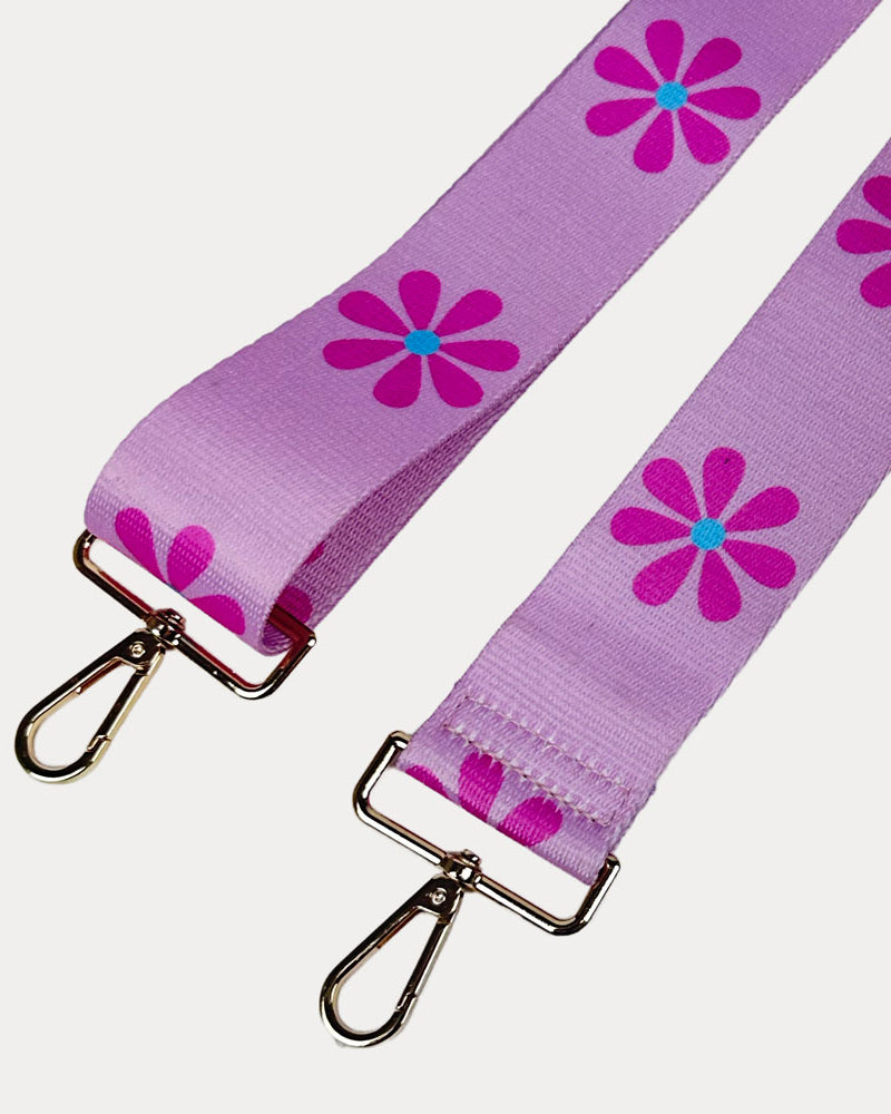 Pink ground with Pink Flower Print bag strap with gold metal clasps on light grey background