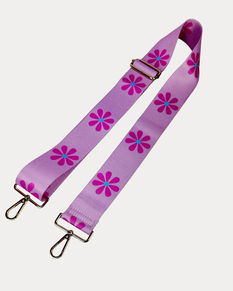 Pink ground with Pink Flower Print bag strap with gold metal clasps on light grey background