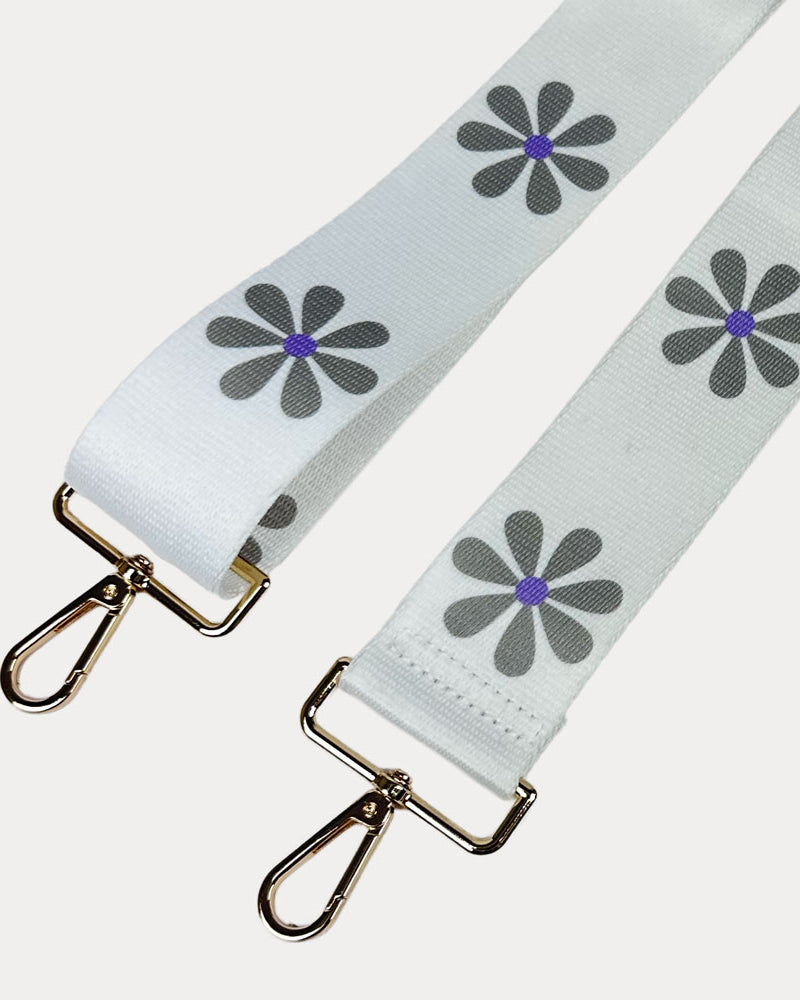 White ground with Grey Flower Print bag strap with gold metal clasps on light grey background