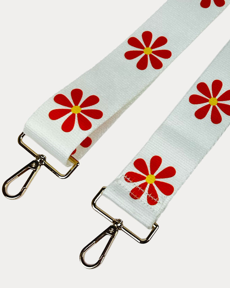 White ground with Orange Flower Print bag strap with gold metal clasps on light grey background