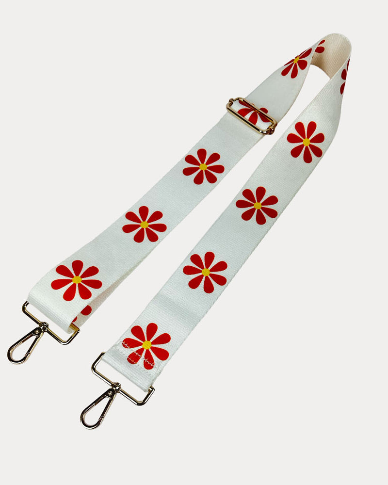 White ground with Orange Flower Print bag strap with gold metal clasps on light grey background