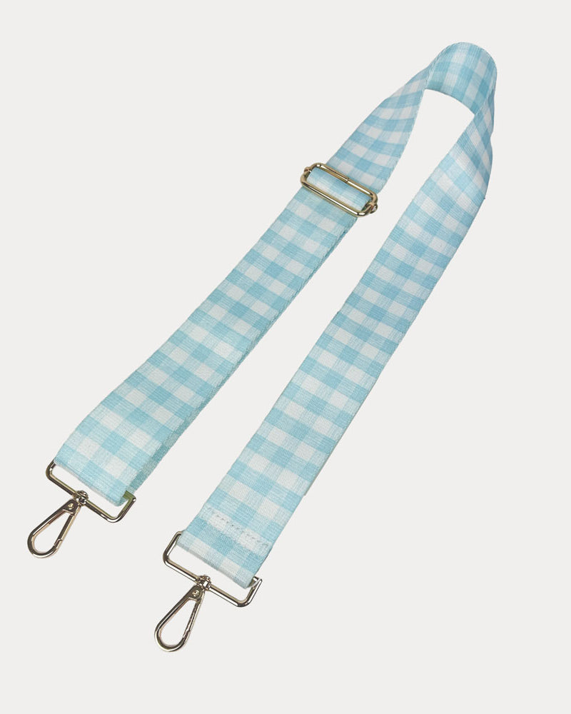 Aqua and white checkered strap with gold metal clasps on a light gray background