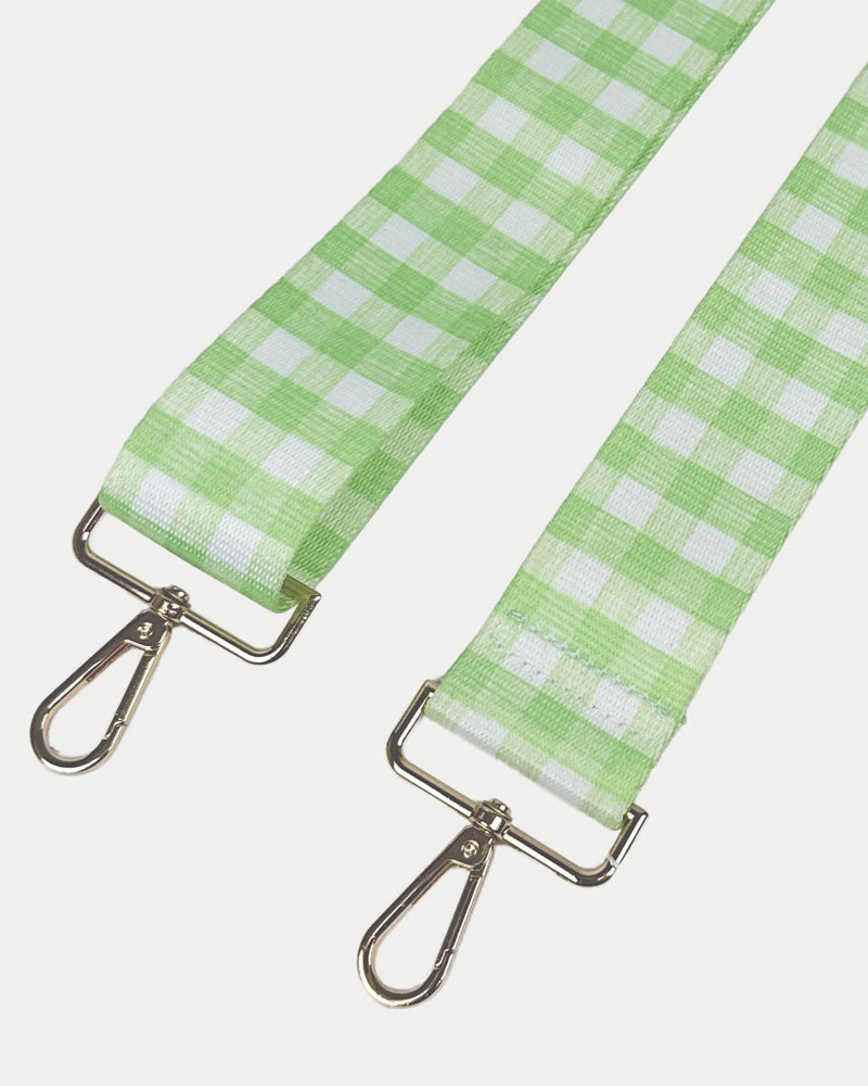 Lime and white checkered strap with gold metal clasps on a light gray background