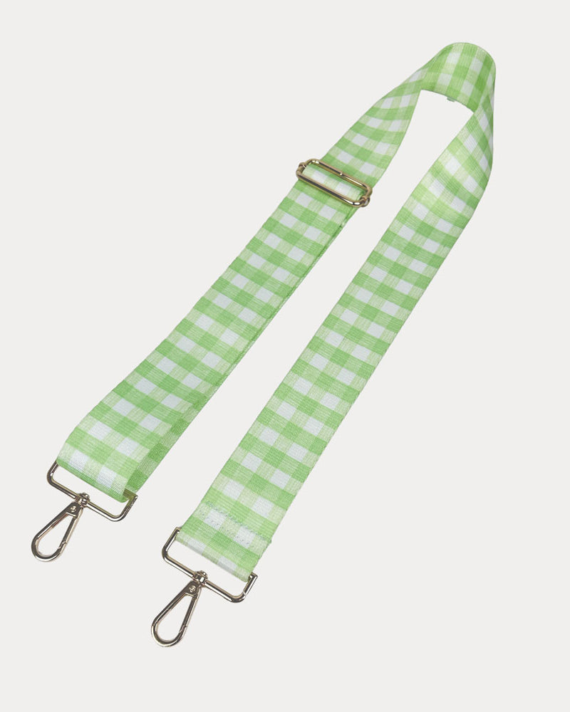 Lime and white checkered strap with gold metal clasps on a light gray background