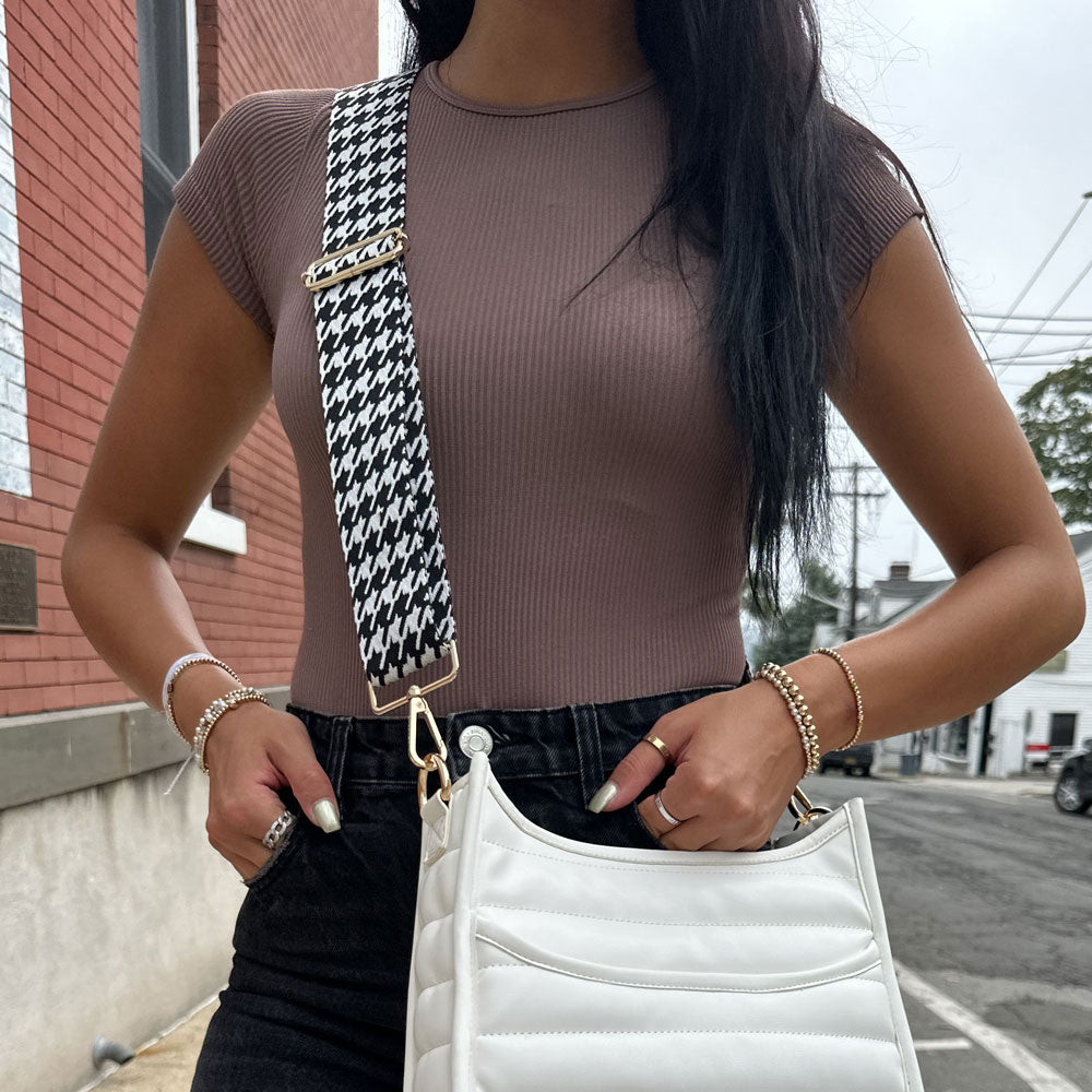 woman wearing woven black & white houndstooth bag strap