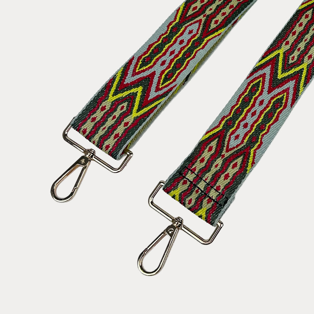 Grey, Army, Red patterned strap with gold hardware on a light grey background