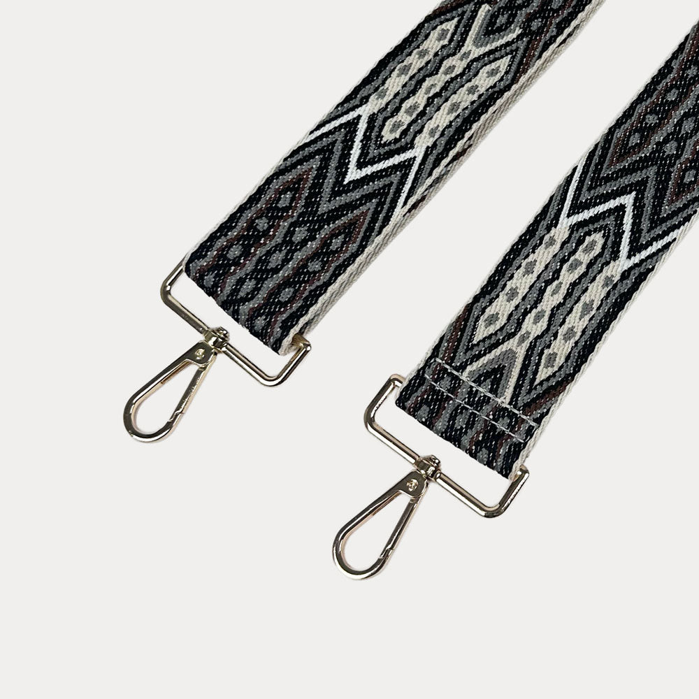 Black, Brown, Grey patterned strap with gold hardware on a light grey background