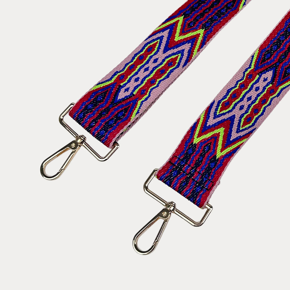 Purple, Red, and Pink patterned strap with gold hardware on a light grey background