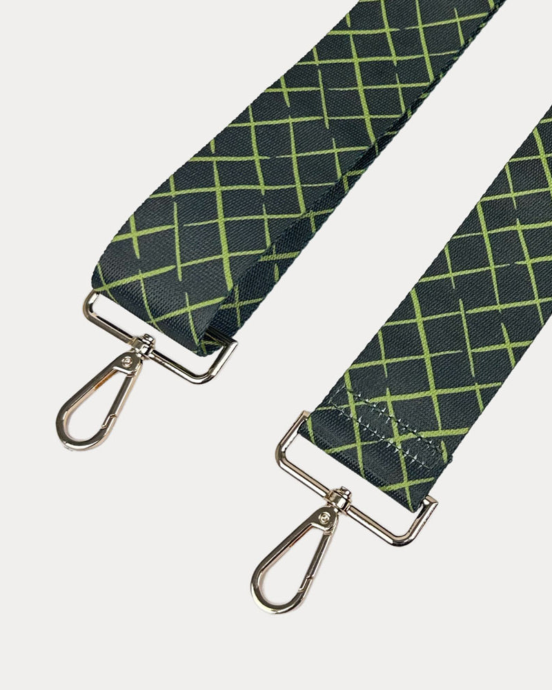 Army green and lime patterned strap with gold hardware on a white background