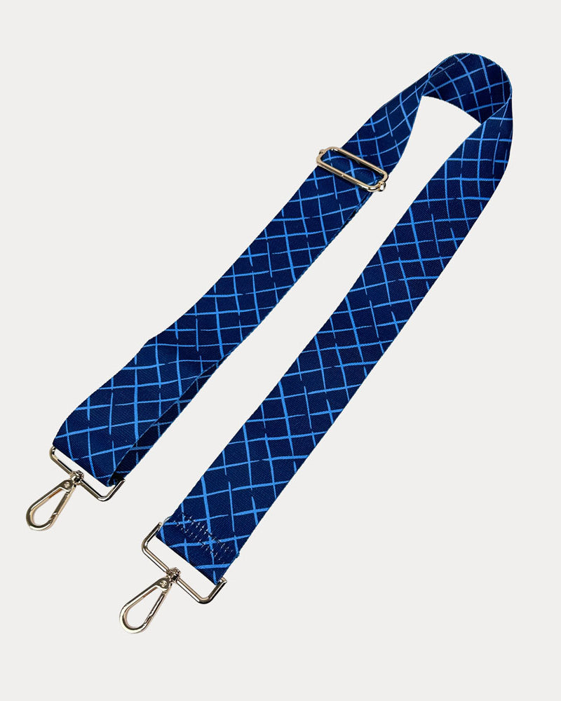 Navy and blue patterned strap with gold hardware on a white background