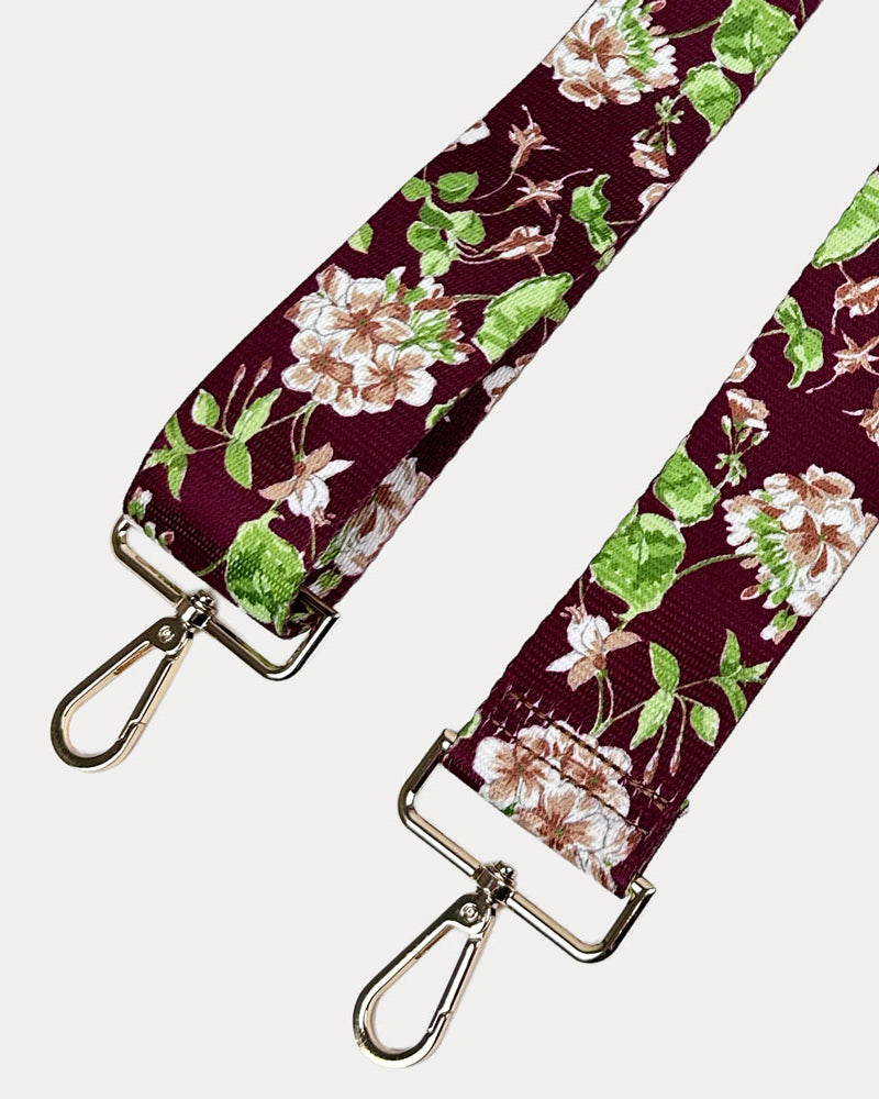Burgundy Ground Floral patterned strap with gold metal clasps on a white background