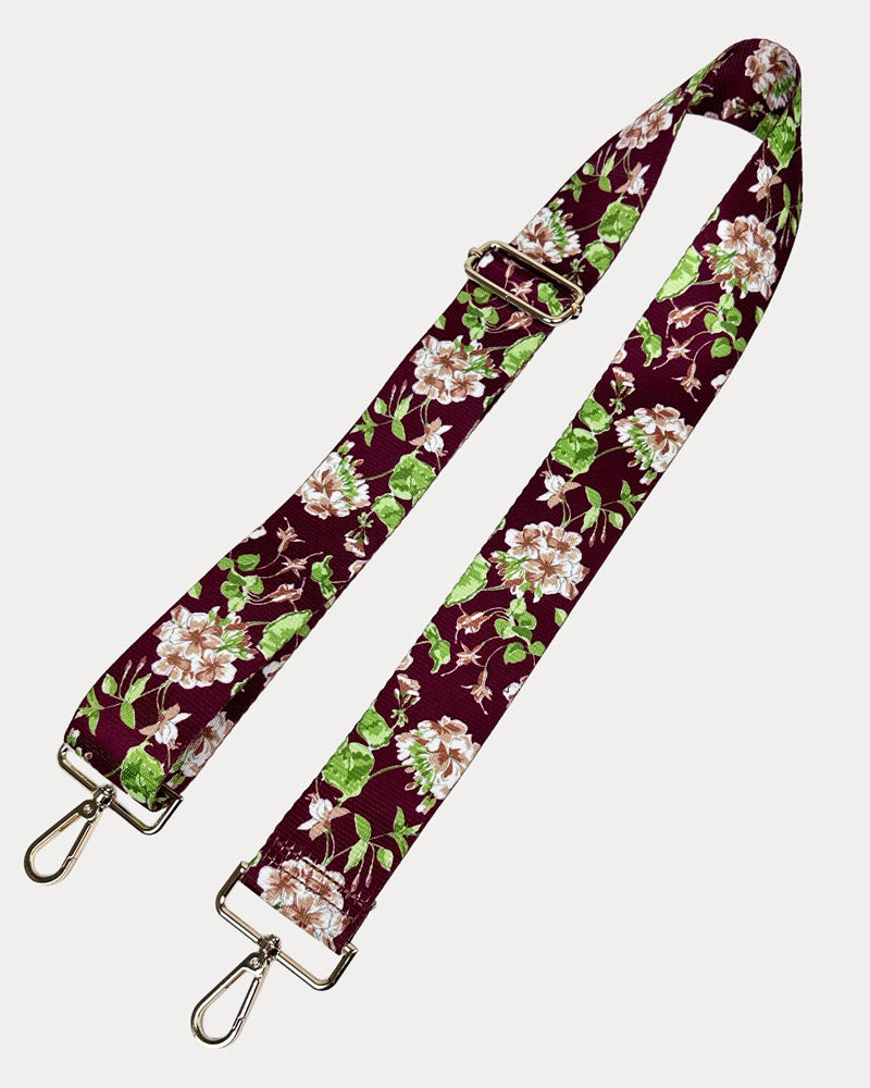 Burgundy Ground Floral patterned strap with gold metal clasps on a white background