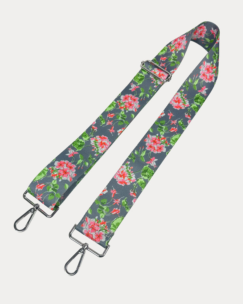 Grey ground floral patterned strap with silver hardware on a light gray background