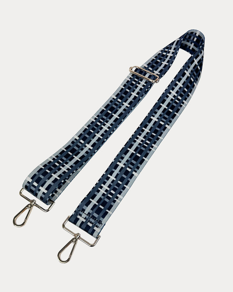 Black and grey plaid strap with gold metal hardware on a white background