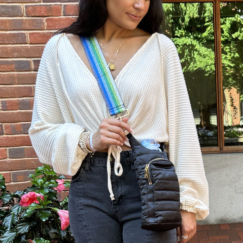 woman wearing the metallic blue & green striped strap