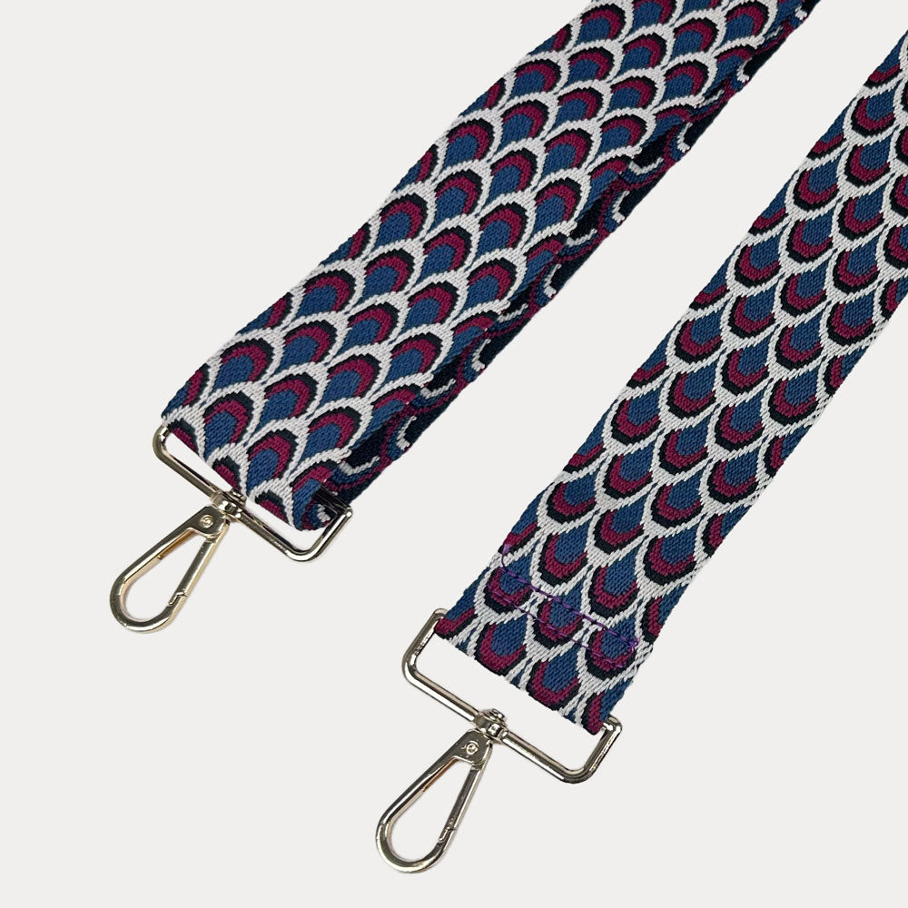 Blue, Burgundy, White patterned bag strap with gold hardware on a light gray background