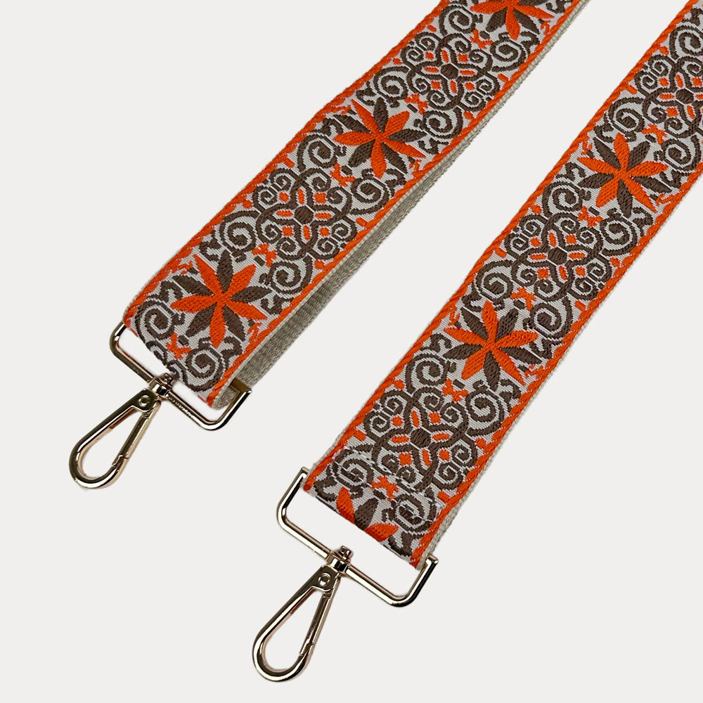 Cream ground with Orange Floral pattern bag strap with gold metal clasps on a light gray background