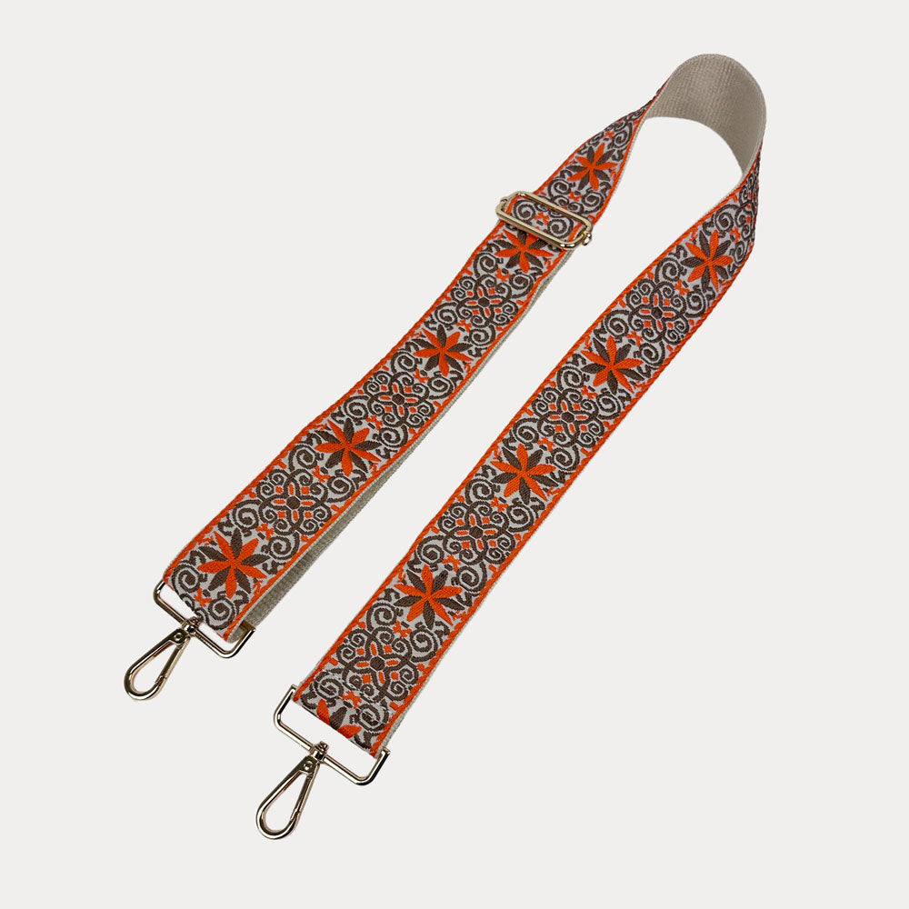 Cream ground with Orange Floral pattern bag strap with gold metal clasps on a light gray background