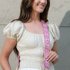 woman wearing the quad woven bag strap in pink