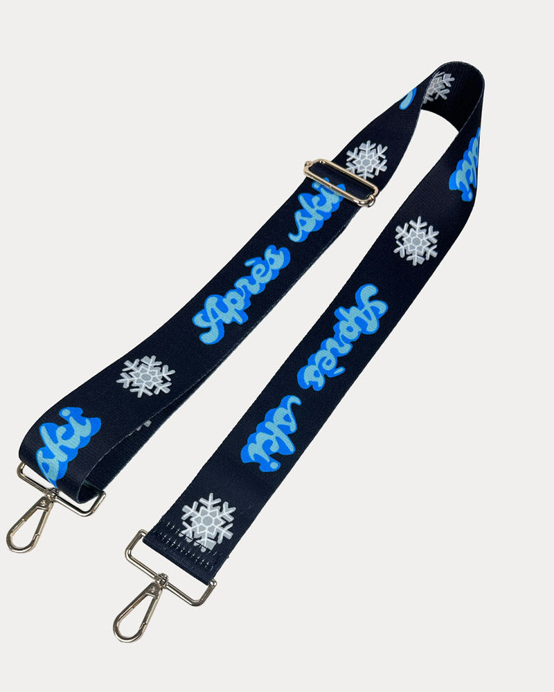 Black ground with Apres Ski text in Blue and white snowflakes printed bag strap with gold hardware