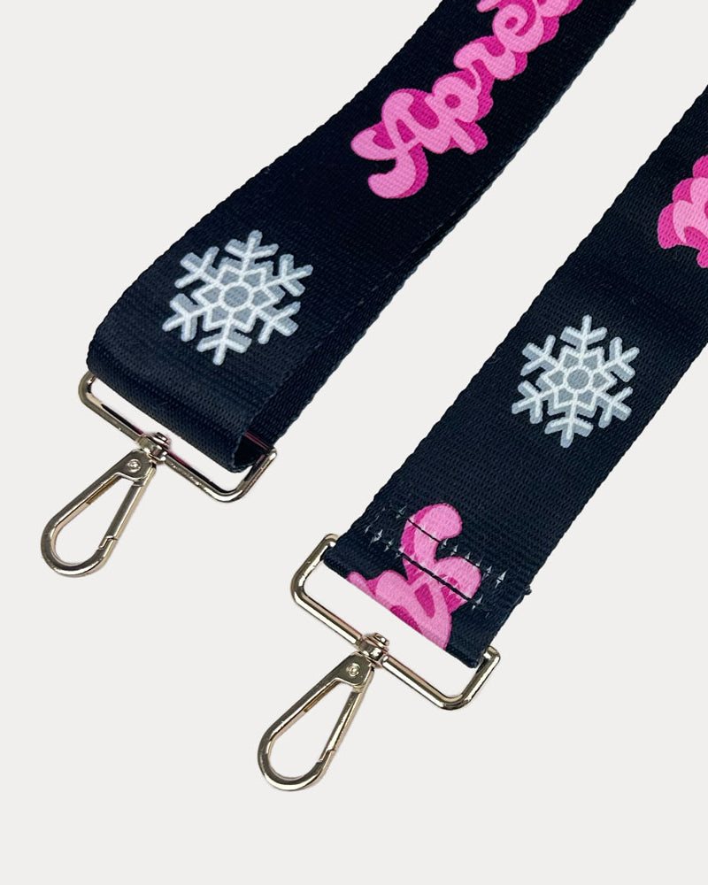 Black ground with Apres Ski text in Pink and white snowflakes printed bag strap with gold hardware