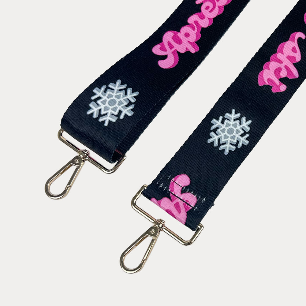 Black ground with Apres Ski text in Pink and white snowflakes printed bag strap with gold hardware