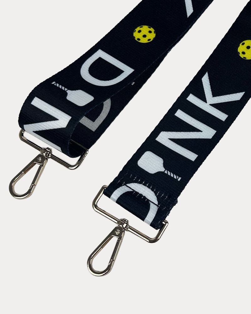 Black ground with Dink text with gold hardware bag strap
