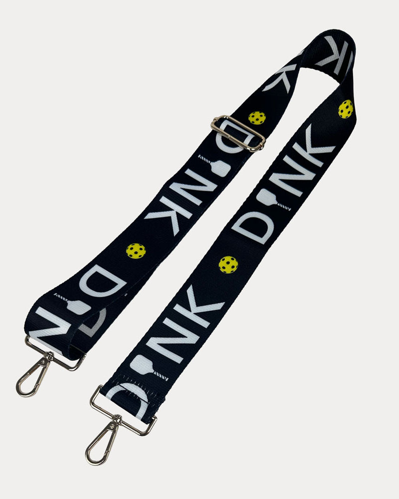 Black ground with Dink text with gold hardware bag strap