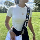 woman wearing "dink responsibly"  black bag strap