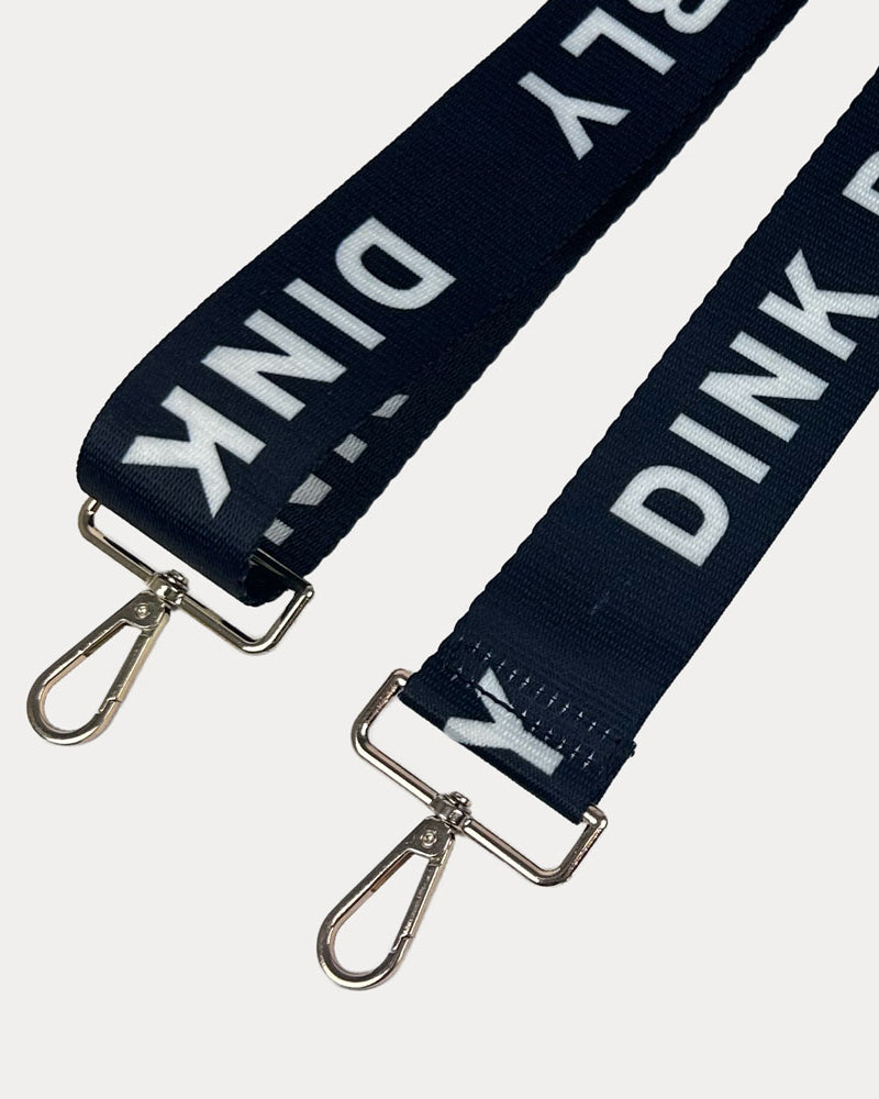 Black ground with Dink Responsibly text with gold hardware bag strap