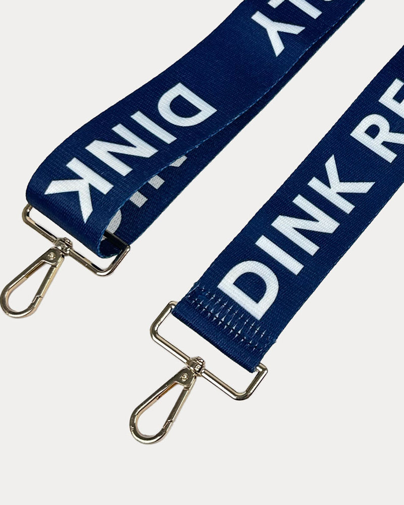 Navy ground with Dink Responsibly text with gold hardware bag strap