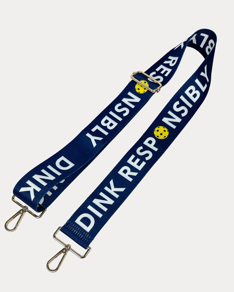 Navy ground with Dink Responsibly text with gold hardware bag strap
