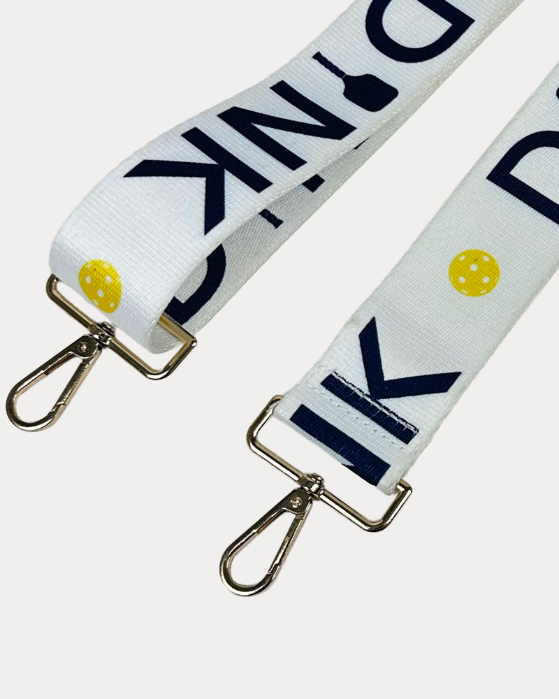 Black ground with Dink text with gold hardware bag strap