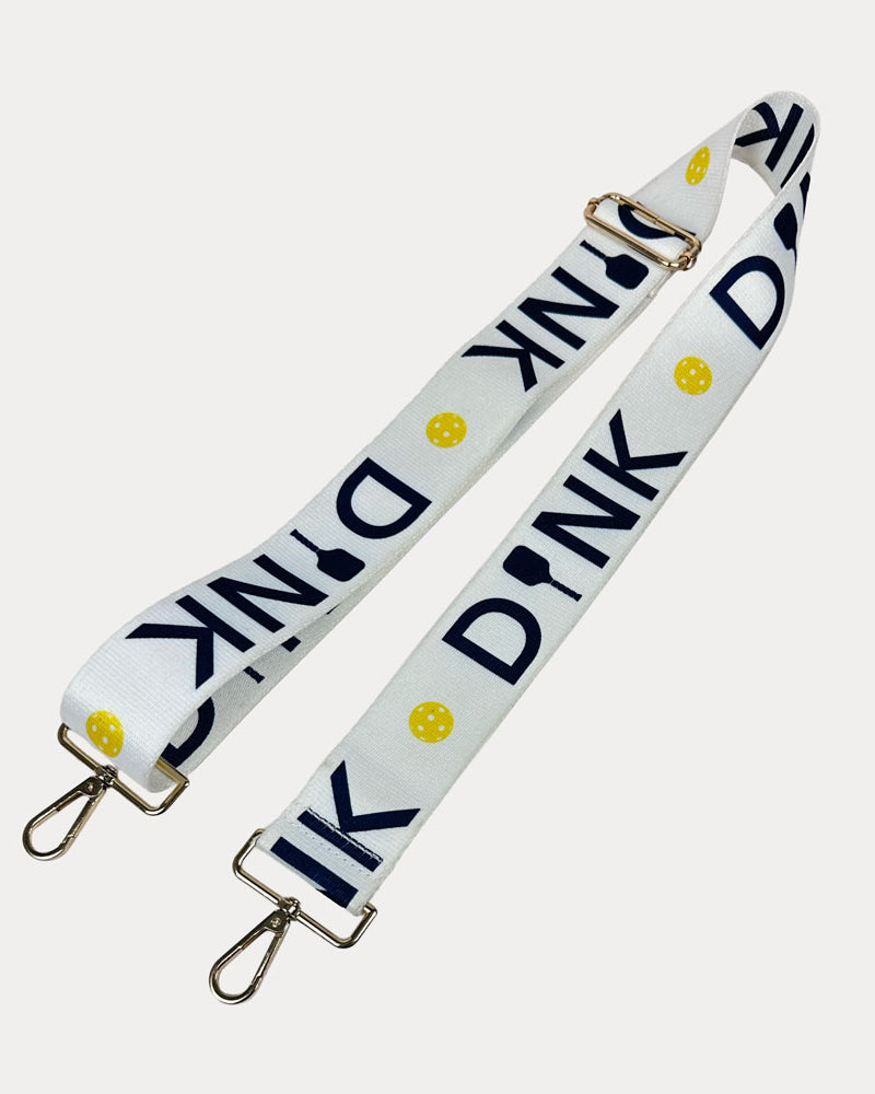 White ground with Dink text with gold hardware bag strap