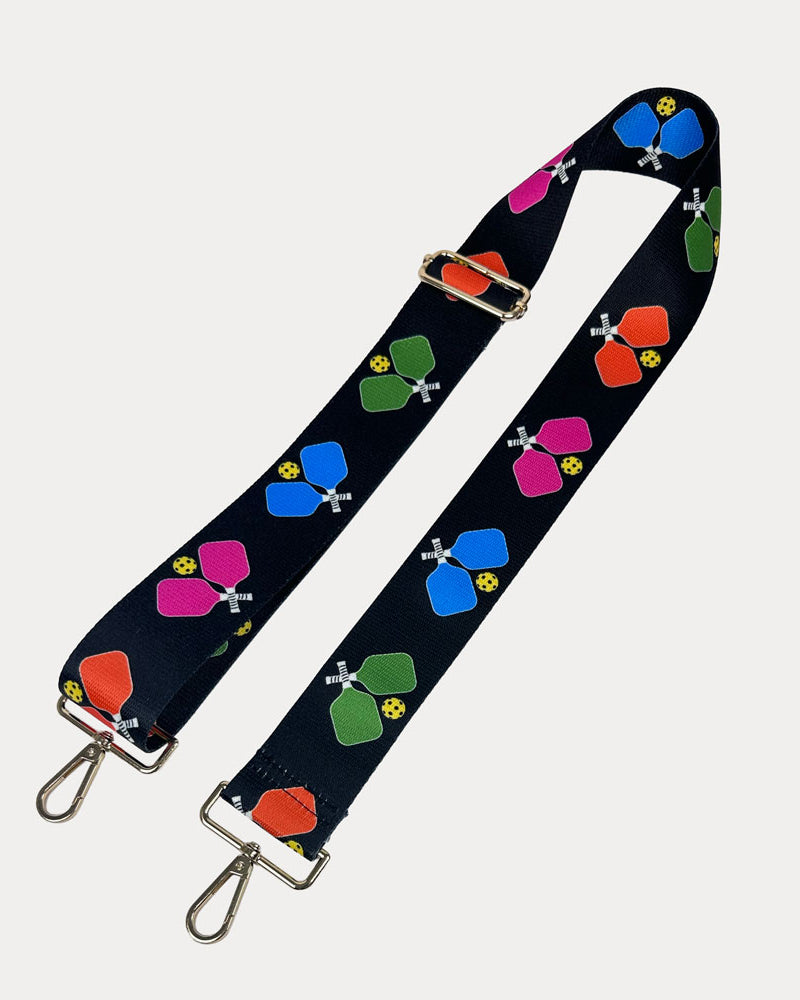 Black ground with colorful pickleball paddle graphics with gold hardware bag strap