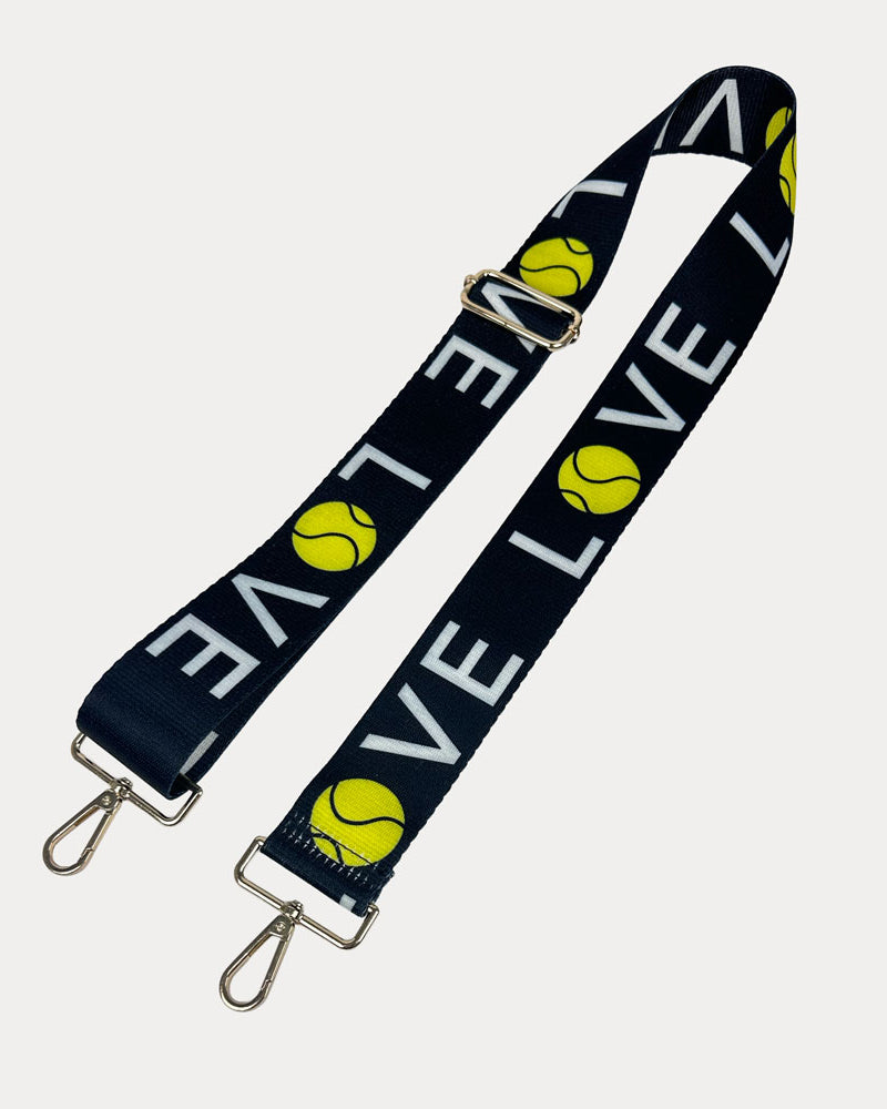 Black ground with 'LOVE' text and tennis ball graphics with gold hardware bag strap