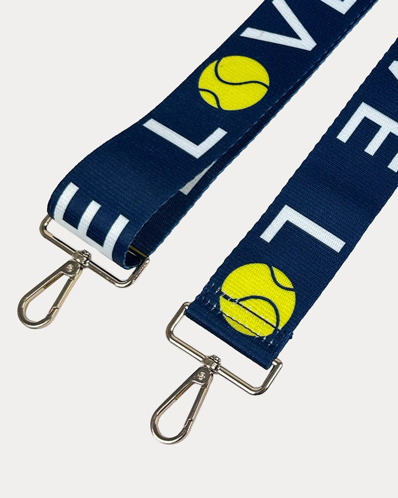 Navy ground with 'LOVE' text and tennis ball graphics with gold hardware bag strap