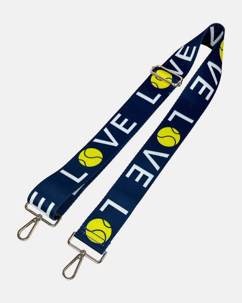 Navy ground with 'LOVE' text and tennis ball graphics with gold hardware bag strap