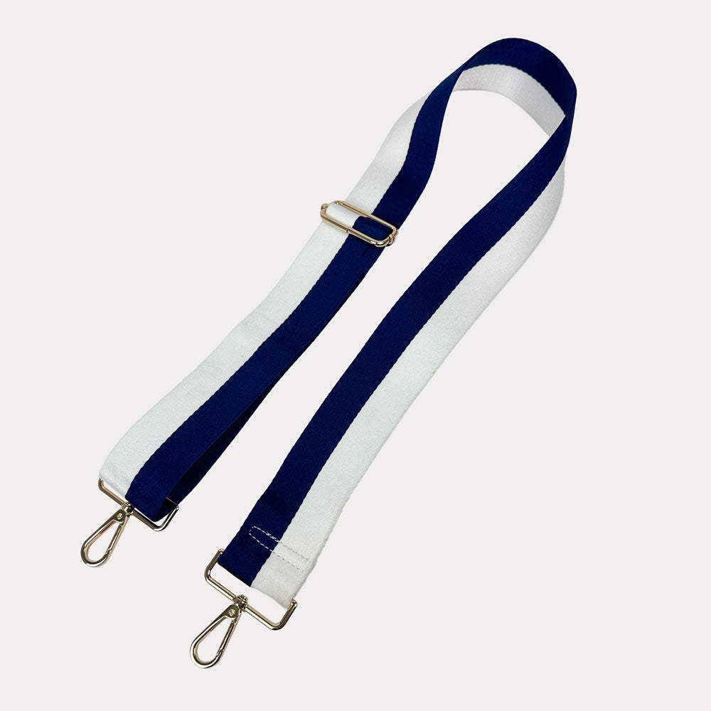 Navy and White striped bag strap with gold hardware on a light gray background