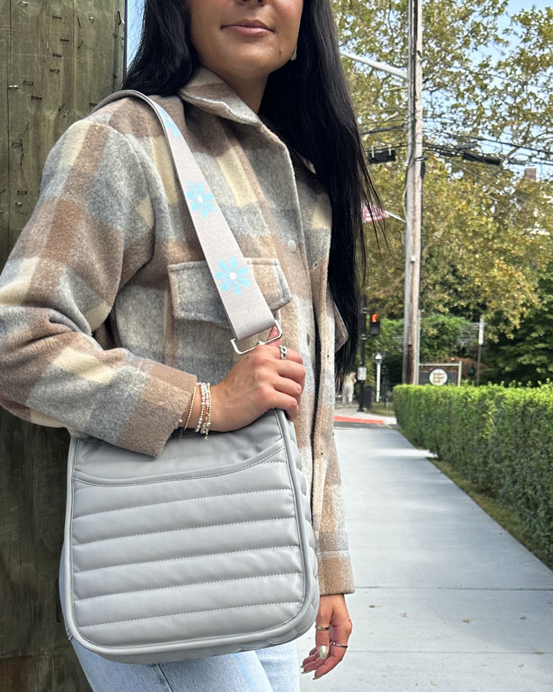 woman wearing the printed flower strap in grey with blue flowers