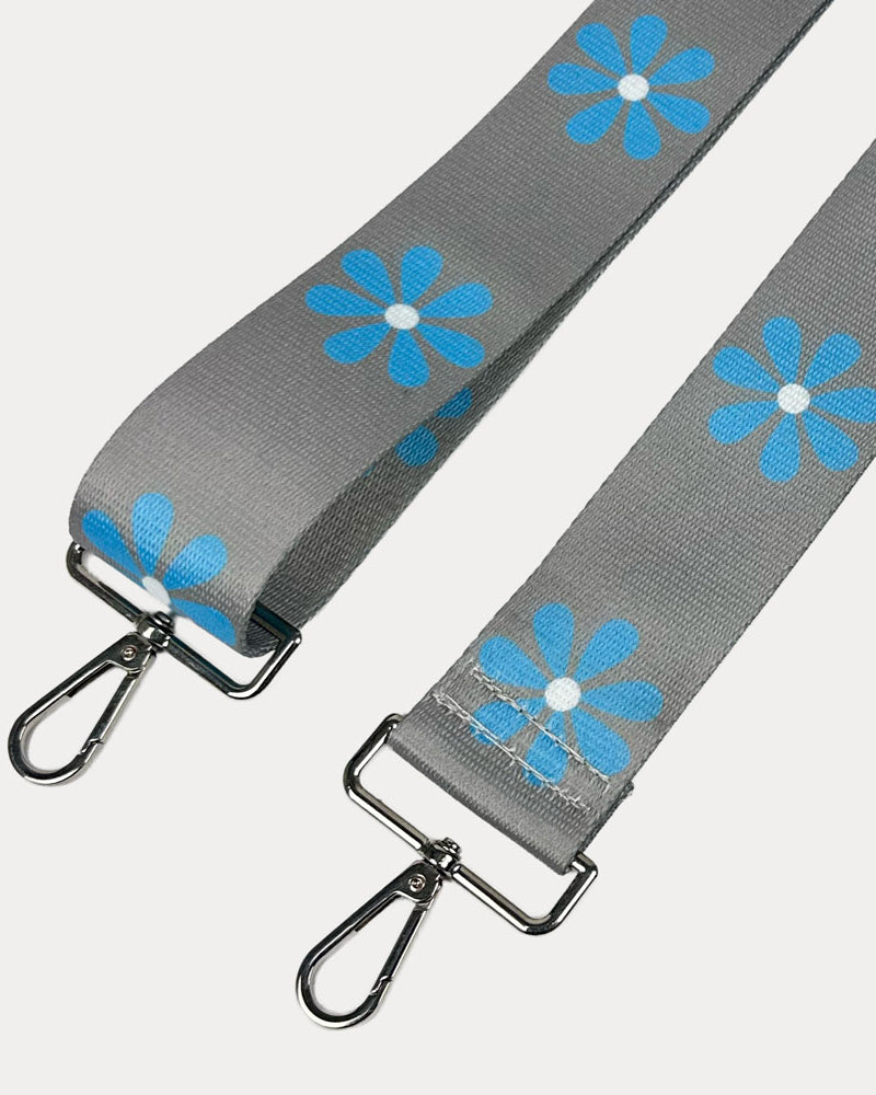 Grey ground with Light Blue Flower Print bag strap with silver metal clasps on light grey background