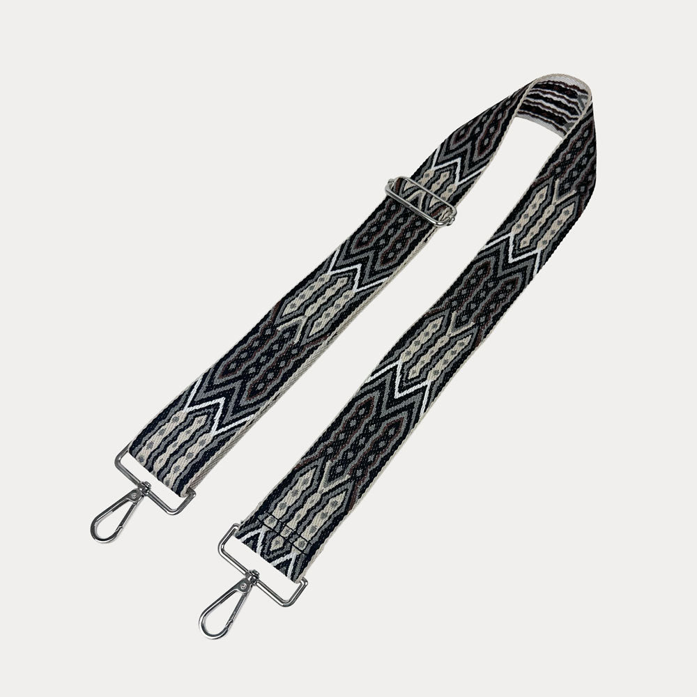Black, Brown, Grey patterned strap with silver hardware on a light grey background